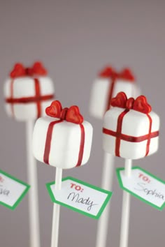 small candy lollipops wrapped in red and white paper with bows on them