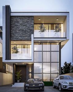 two cars parked in front of a modern house