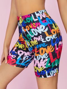 a woman wearing colorful shorts with the word love on it and letters all over them