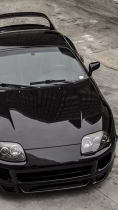 the front end of a black sports car