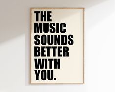 a black and white poster with the words music sounds better with you on it hanging on a wall