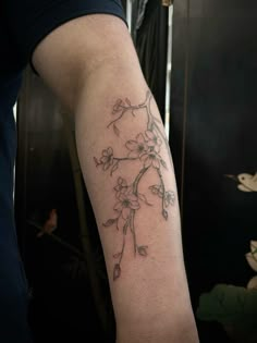 a person with a flower tattoo on their arm