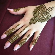 a woman's hand with henna tattoos on it