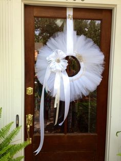 a white tulle wreath on the front door