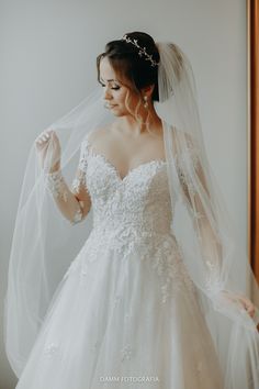 a woman wearing a wedding dress and veil