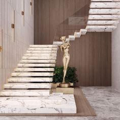 the stairs are made of marble and have a statue on one side, along with a potted plant in the other