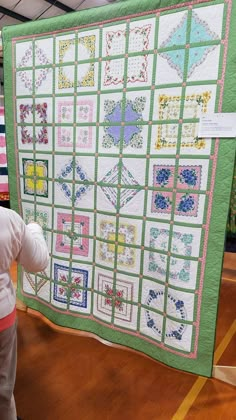 a young child looking at a quilt on display