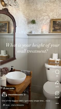 a bathroom with a sink, toilet and mirror on the wall that says what is your height of your wall treatment?