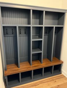 an empty room with some gray shelves and wood flooring on the side walk - in closet