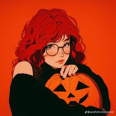 a woman with red hair and glasses holding a pumpkin