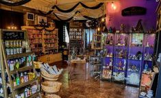 the inside of a store filled with lots of items and baskets on display in front of it