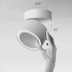 a hand holding up a light fixture with measurements for the top and bottom part of it