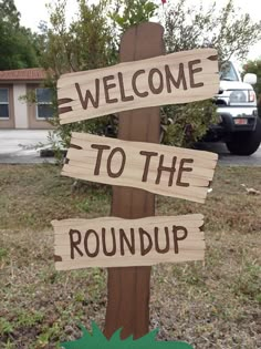 a wooden sign that says welcome to the roundup