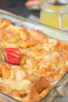 a close up of a casserole in a pan with strawberries on top