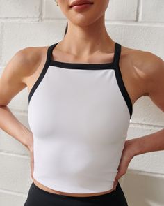 Slim-fitting active tank in our comfortable sculptLUX active fabric. Designed to hold you in, our sculptLUX fabric is soft, sculpting and flattering. Features a cropped length, on-trend apron neckline, interior lining with removable pads and adjustable straps. Stylish Apron, Female Features, Plisse Fabric, Workout Wardrobe, American Clothing, Workout Tank Tops, Hold You, Active Women, White Material