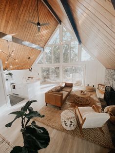 a living room filled with furniture next to a kitchen