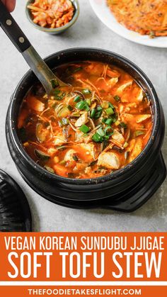 vegan korean sundul jigae soft tofu stew with vegetables in a black bowl