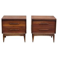 a pair of nightstands with two drawers and one drawer on each side, both in walnut