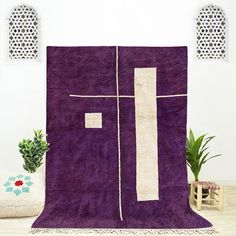 a purple area rug with white trim on it