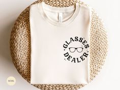 👓 Step up your style game with this Glasses Dealer Optician Shirt! Designed for opticians, optometry technicians, and anyone passionate about eyeglasses, this shirt is a must-have addition to your wardrobe. Whether you're working in an optometry office or just love everything about eyewear, this shirt is a perfect way to showcase your expertise and enthusiasm. 👓 SPECS: * Bella + Canvas 3001 * UNISEX sizing * 100% airlume combed and ringspun soft cotton; please refer to size chart in listing ph Optometry Halloween Costumes, Ophthalmology Christmas, Optometry Assistant, Optician Shirts, Ophthalmic Technician Gifts, Optician Quotes Optometry Humor, Optometry Halloween Shirts, Optical Office, Optician Training