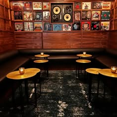 an empty booth with tables and records on the wall