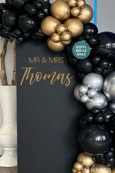 there is a sign that says mr and mrs thomas with balloons in the shape of letters