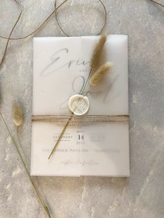 the wedding card is tied up with twine