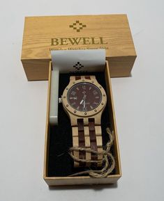 Elevate your style with this Bewell ZS-W109A Men's Quartz Wood Wristwatch. The watch features a round face with Roman numerals, a 45mm wooden case, and a folding clasp with safety. The sandalwood and maple wood band is perfect for any casual or business occasion. This wristwatch is designed for men and has a quartz movement powered by battery. The watch is analog and has a display of Roman numerals. The Bewell brand is known for its quality and this watch is no exception. The lug width is 26mm, and the case size is 45mm. This wristwatch is perfect for anyone looking for a stylish and functional accessory. Wooden Watch, Men Gifts, Wooden Case, Functional Accessories, Roman Numerals, Maple Wood, The Watch, Quartz Movement, Accessories Watches