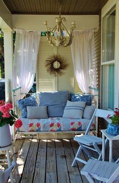 the porch is decorated with blue and white furniture