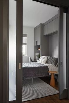 a bed sitting next to a window in a bedroom