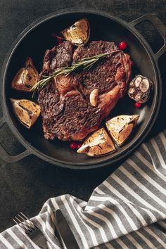 steak and potatoes in a skillet on a table