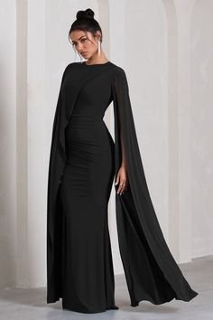 Defined by an extravagant asymmetric cape, Magdelena is a sophisticated option for your next black tie wedding or race day event. Crafted in our signature stretch jersey, this black maxi dress features a high neckline and gathered waist before falling into an elegant floor sweeping skirt. Features - Premium stretch jersey- High neckline - Asymmetric cape- Invisible zip closure - Gathered waist tucks- Maxi length Sizing & Fit Model is 5'8" and wears UK size 8 / US size 4 Product Information Desig Prewedding Clothes, Dresses Soiree, Asymmetric Cape, Black Wedding Guest Dresses, Ascot Dresses, Classy Gowns, Classy Wedding Dress, Dinner Dress Classy, Wedding Dress Guide