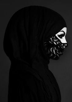 a woman wearing a black veil and mask