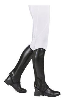 a person wearing riding boots and white pants