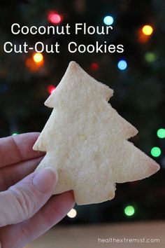 coconut flour cut out cookies in front of a christmas tree with the words coconut flour cut out