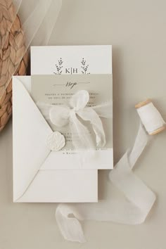 the wedding stationery is laid out on top of the table with ribbons and ribbon