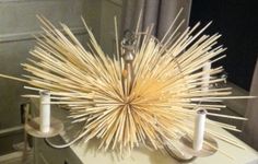 a bunch of sticks sitting on top of a white counter in front of a mirror