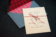 a christmas card tied with twine on top of an envelope