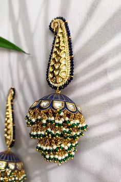 Blue enamel meenakari handpainted chandbaali featuring glass kundan work, cubic zirconia studs, pearl embellishments and plated with 22kt gold. These pretty earrings are a perfect match to all things pastels. The earring features pretty floral motif in glass kundan work and delicate cubic zirconia. The chandbali are embellished with high grade shell pearls. These earrings are handpainted by artisans of Kashmir who are famous for papier-mache artwork. Detailed hand painting alongside studded kund Blue Temple Jewelry Jhumkas For Celebration, Festive Blue Tilla Jhumkas, Temple Style Blue Jhumkas For Celebration, Blue Temple Jewelry Jhumkas Gift, Blue Cutdana Earrings For Wedding, Blue Cutdana Wedding Earrings, Fusion Kundan Jhumkas With Meenakari, Fusion Style Kundan Jhumkas With Meenakari, Blue Tilla Jhumkas For Gift