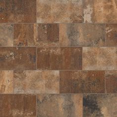 a brown and tan tile floor with different colored tiles on the sides, including one that looks like an old brick wall