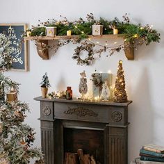 a fireplace decorated for christmas with candles and decorations