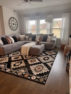 a living room filled with furniture and a large rug