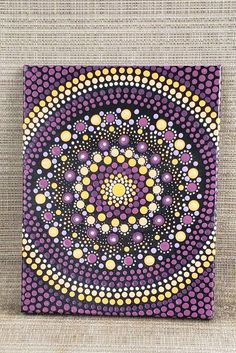 a purple and yellow painting with circles on it