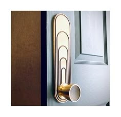 a door handle on the side of a blue door with gold trim and two white cups