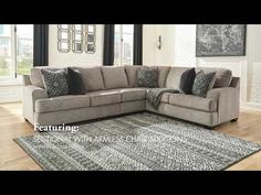 a large sectional couch with pillows on top of it