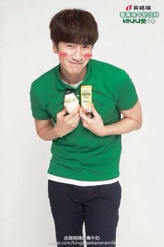 a young man holding two packages of food