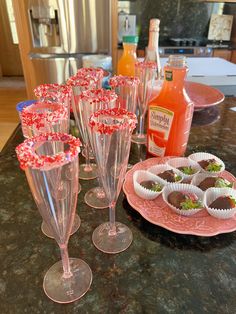 there are many wine glasses on the table with candy in them and some candies