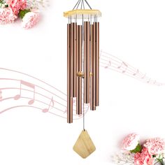 a wind chime with musical notes and flowers