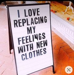 a sign that says i love replacing my feelings with new clothes on it