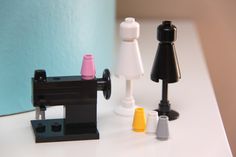 there are three different types of toy sewing machines on the counter top, and one is made out of legos